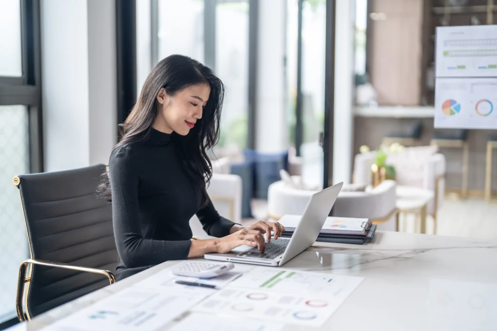 beautiful-confident-asian-business-woman-working-with-laptop-hands-typing-keyboard-professional-investor-working-new-start-up-project-business-planning-office-technology-business